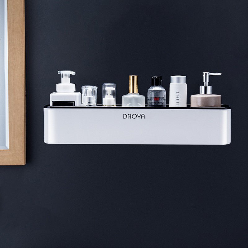 Self-adhesive black bathroom organizer rack for shampoo and skincare.